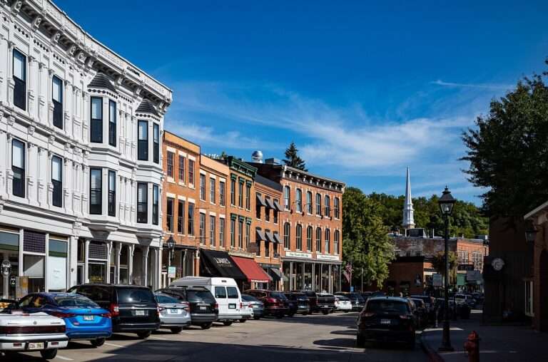 Brick storefronts and a white church steeple along the curve of Galena's Main Street